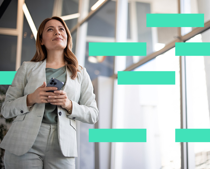 Lady holding a phone in office atrium