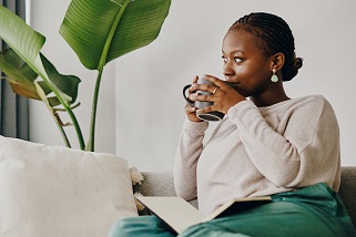 Woman on sofa with cup of tea