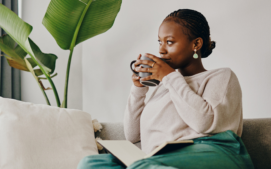 Woman on sofa with cup of tea