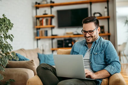 Man At Home Using Computer