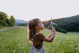 Girl blowing a windmill