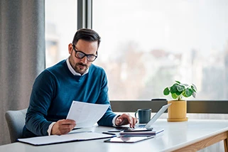 Man sat at desk looking at papers