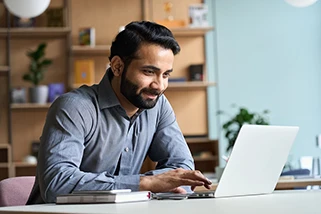 Young man looking at a laptop