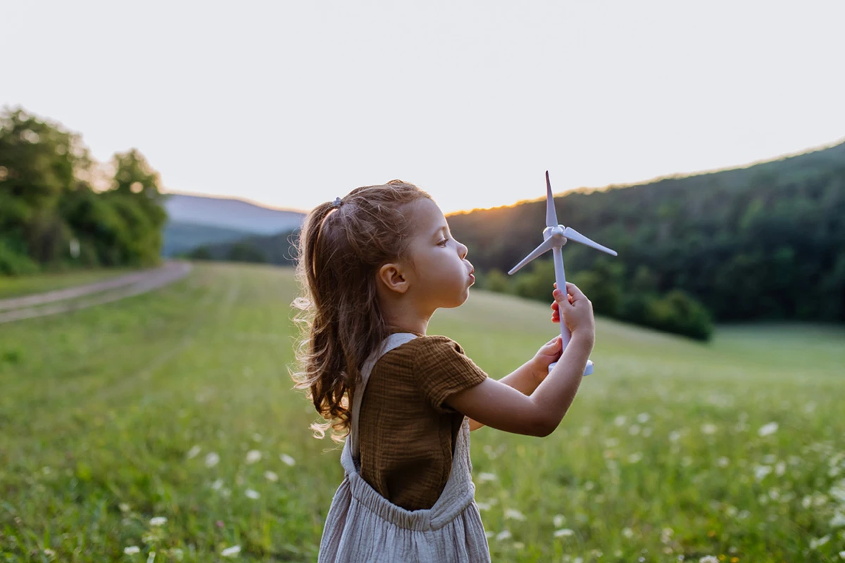 Girl blowing a windmill