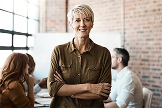 Employer in office with arms crossed