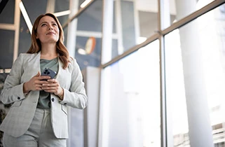 Lady holding a phone in office atrium